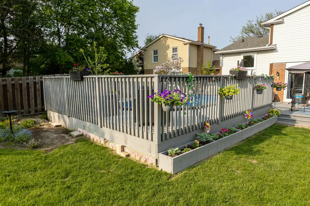 A backyard deck inside a wood privacy fence