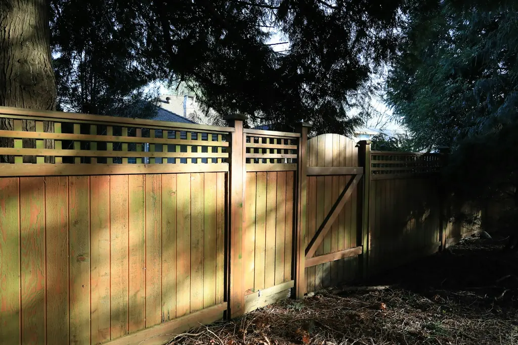 A wood privacy fence with a gate